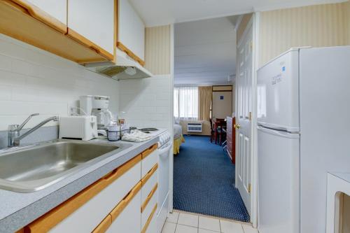 a kitchen with a sink and a refrigerator at The Spinnaker in Ocean City