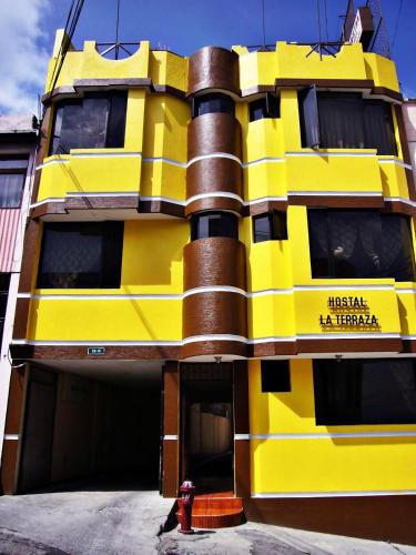 a yellow building with a fire hydrant in front of it at Hostal La Terraza - Roof Terrace Overlooking The North and Historic Centre in Quito
