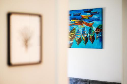 a picture of some fish on a wall at Baltic Apartments in Pobierowo