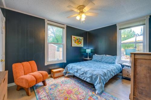 una camera da letto con un letto, una sedia e finestre di 4 Mi to Liberty U Huge Home with Yard and Hot Tub a Lynchburg