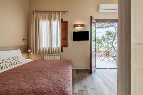 a bedroom with a bed and a sliding door with a patio at Salamureci Camere in Trapani