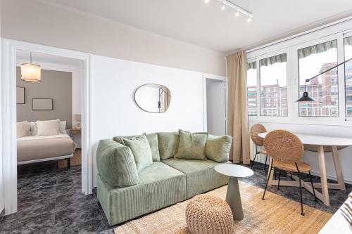 a living room with a couch and a bedroom at 3 Bdr Apt In Cornella 5 Mins Form The Metro in Cornellà de Llobregat