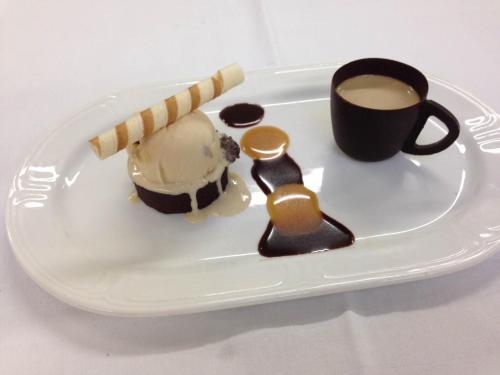 a plate with a dessert and a cup of coffee at Abbey Hotel Roscommon in Roscommon
