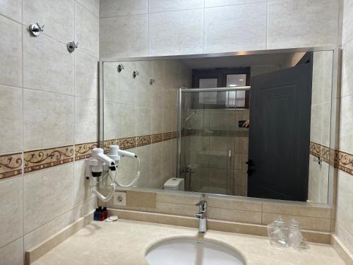 a bathroom with a sink and a mirror at Hotel Peninsula in Istanbul