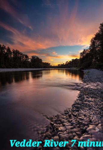 a view of a river with a sunset in the background at Spacious 2BR Near HWY 1, Heritage Park , Cultus Lake & Fishing! in Chilliwack