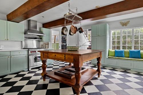a kitchen with green cabinets and a wooden table at Rabbit Run in Sawyer