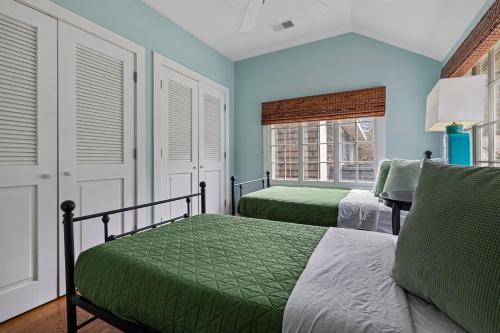 a bedroom with two beds and two windows at Rabbit Run in Sawyer