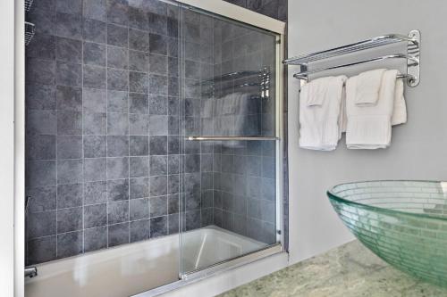 a bathroom with a shower with a sink and a tub at Rabbit Run in Sawyer