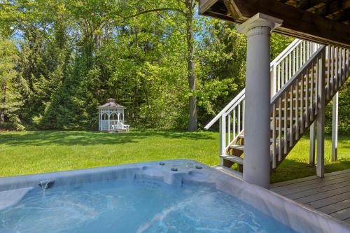 a hot tub on a deck with a gazebo at Rabbit Run in Sawyer