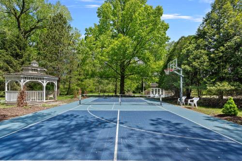 a tennis court with a gazebo and a basketball hoop at Rabbit Run in Sawyer