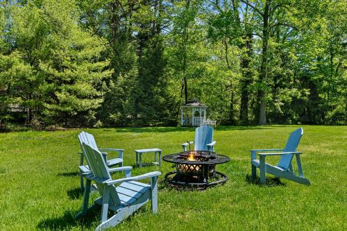 a group of chairs around a fire pit in the grass at Rabbit Run in Sawyer