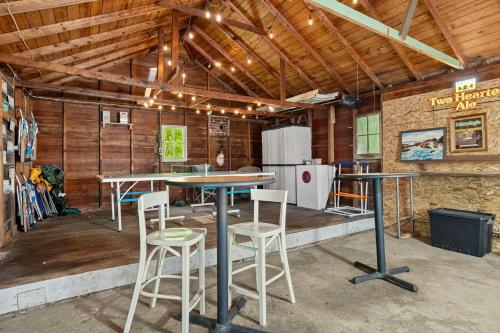 a kitchen with tables and stools in a barn at Rabbit Run in Sawyer