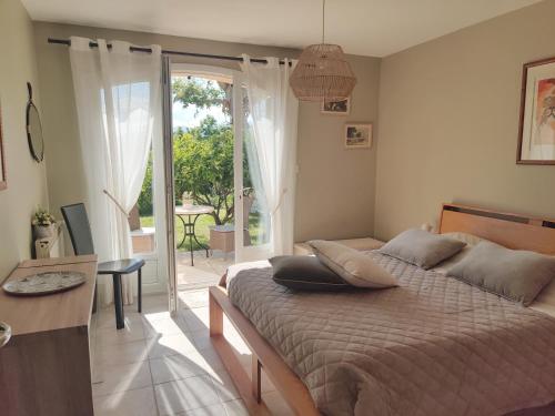 a bedroom with a bed and a door to a patio at Les collines de St Paul in Saint-Paul-de-Vence