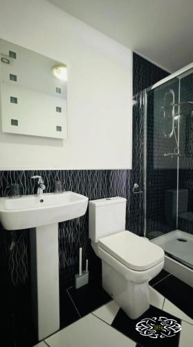 a bathroom with a white toilet and a sink at Royal Marine Hotel Dunoon in Kirn