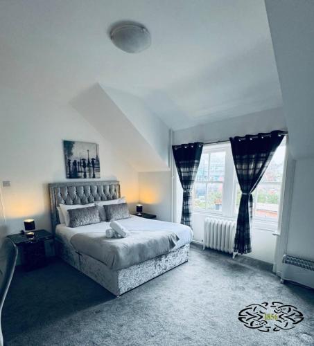a bedroom with a large bed and a window at Royal Marine Hotel Dunoon in Kirn