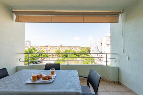 a table with a plate of food on a balcony at Apartment Matea with terrace in Zadar
