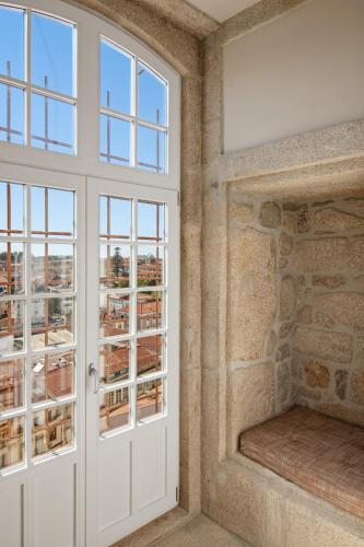 an empty room with a door and windows at The Lince Santa Clara in Vila do Conde