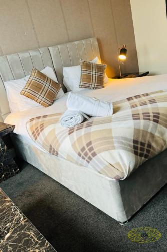 a bedroom with a large bed with pillows at Royal Marine Hotel Dunoon in Kirn