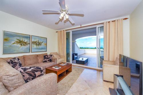 a living room with a couch and a ceiling fan at Hotel La Vista Azul in Turtle Cove