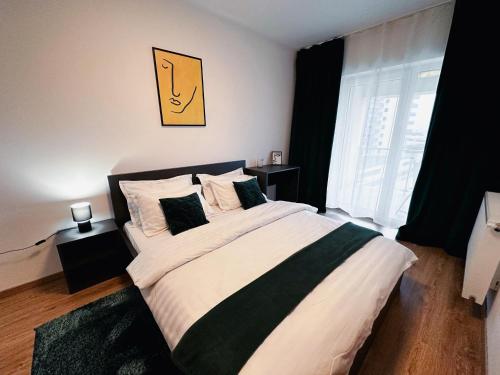 a bedroom with a large bed and a window at AD Apartments in Cluj-Napoca