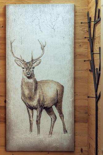 a painting of a deer on a wall at Hotel Villa Alpina ***S in Cortina dʼAmpezzo