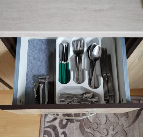 a drawer filled with utensils on a table at La Moieciu pe Deal in Moieciu de Jos