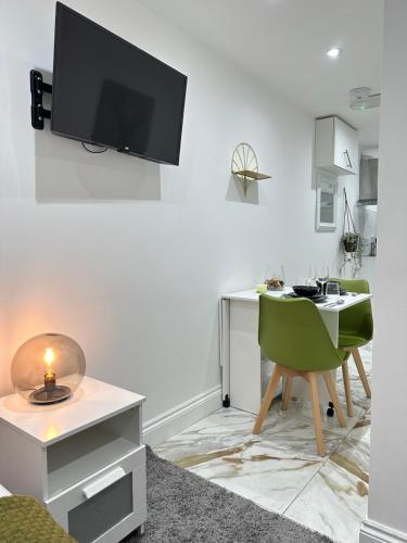 a living room with a desk and a tv on the wall at Tower Bridge Studios in London