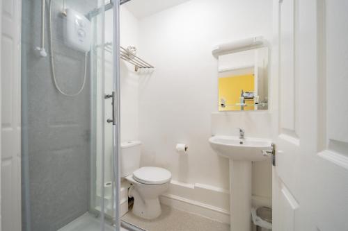 a bathroom with a toilet and a sink and a shower at The Well Inn in Shepton Mallet