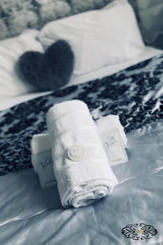 a bed with two rolls of towels on it at Royal Marine Hotel Dunoon in Kirn