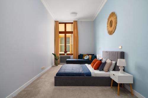 a bedroom with two beds with blue walls at AS HOME Apartamenty Rynek 50 R503 Amazing View in Wrocław