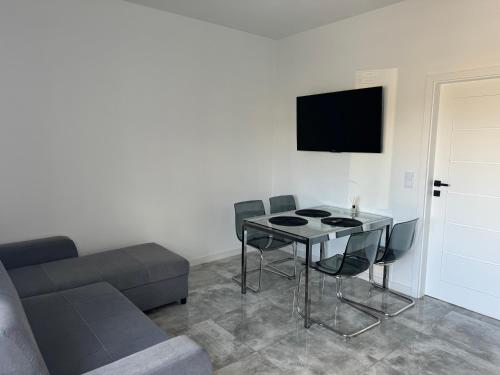 a living room with a table and a couch at Kamyczek in Gąski