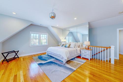 a bedroom with a bed and a large window at Pleasantries in South Chatham