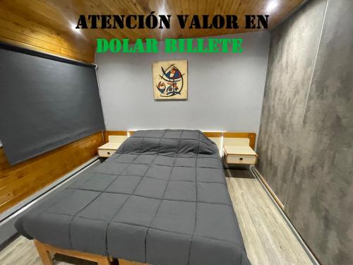 a bed in a room with a chalk board at Departamento en Edificio Atenas con excelentes Vistas in Las Lenas
