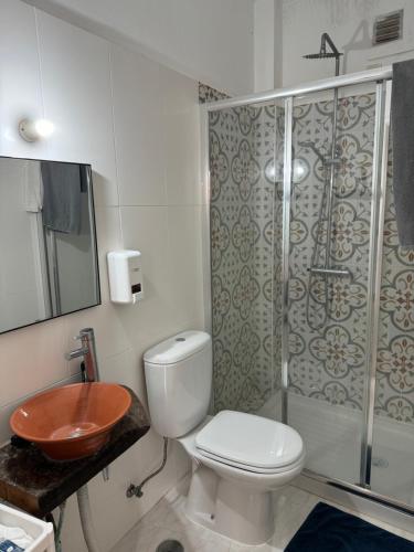 a bathroom with a toilet and a shower and a sink at Casa da Moura in Moura