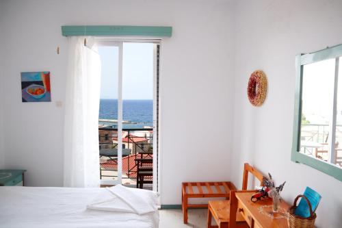 a bedroom with a bed and a view of the ocean at Atlantis in Samos