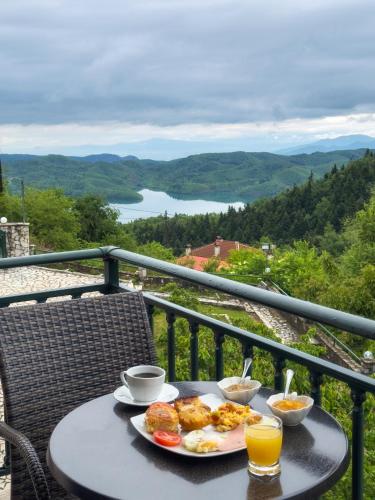 a table with a plate of food on a balcony at Nefeles in Neochori