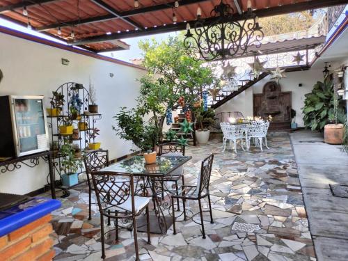 a patio with a table and chairs and a fireplace at HOTEL CASA LIMON in Santa Rosa de Jáuregui