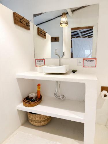 a bathroom with a sink and a mirror at Casa da Glória Trancoso - Pousada Boutique in Trancoso