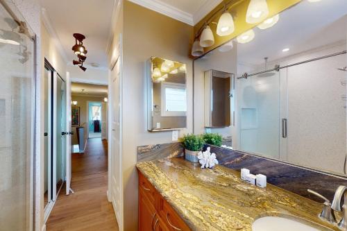 a bathroom with a sink and a large mirror at Kuapa Isle Gem Unit 419 in Honolulu