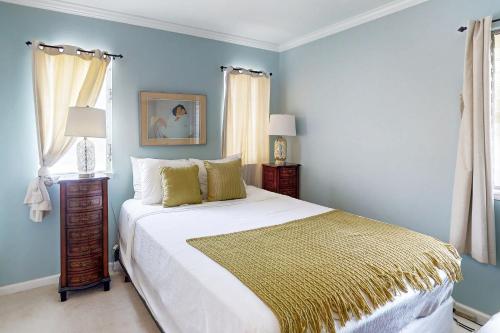 a bedroom with a large bed with blue walls at Kuapa Isle Gem Unit 419 in Honolulu