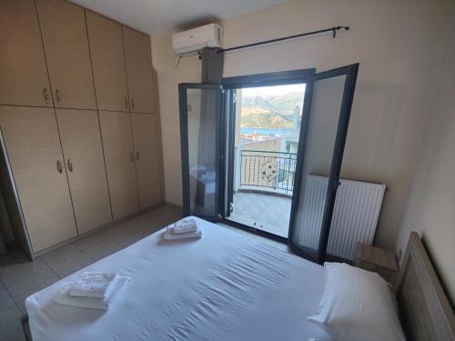 a bedroom with a bed and a large window at Argostoli bay view in Argostoli