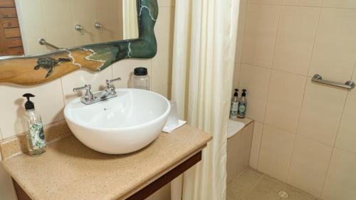 a bathroom with a sink and a shower at Hotel Galapagos Suites B&B in Puerto Ayora