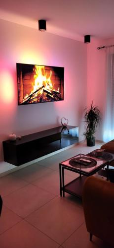 a living room with a fire in a fireplace at Apartament JB 56m2 parking,balkon,2sypialnie in Legnica