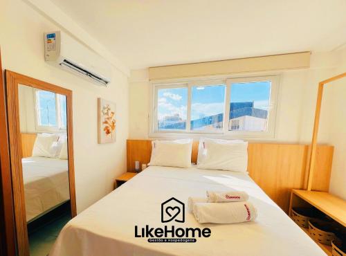 a room with a bed and two windows at Paradise Pé na Areia -Bessa, LikeHome in João Pessoa
