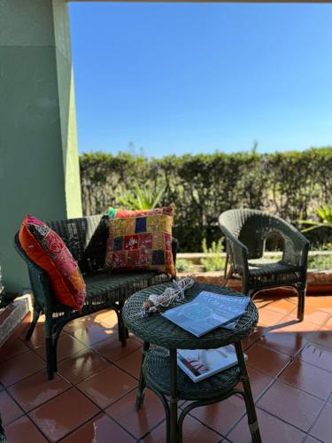 a patio with two chairs and a couch and a table at Sun Holidays Home in Marina di Modica