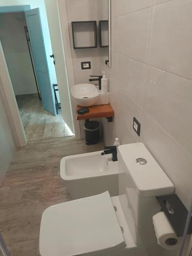 a bathroom with a white toilet and a sink at B&B Borgo Sabelli - Costa dei Trabocchi in Casalbordino