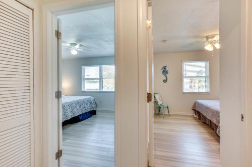 a door leading into a bedroom with two beds at Walk to Pier St Augustine Beach Condo with Balcony! in Saint Augustine Beach