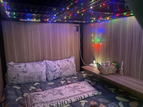 a bedroom with a bed with lights on it at Start House DORM Walk 5 Minutes to the Airport in Ho Chi Minh City