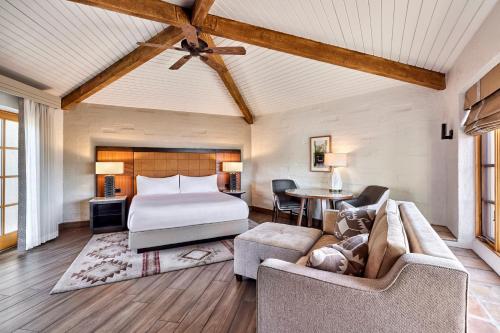 a bedroom with a bed and a couch and a table at JW Marriott Scottsdale Camelback Inn Resort & Spa in Scottsdale