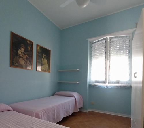 a bedroom with two beds and a window at Appartamento MareBello in Sperlonga